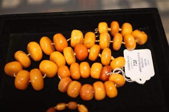 A single strand disc shaped amber bead necklace and matching bracelet, necklace 18.5in.